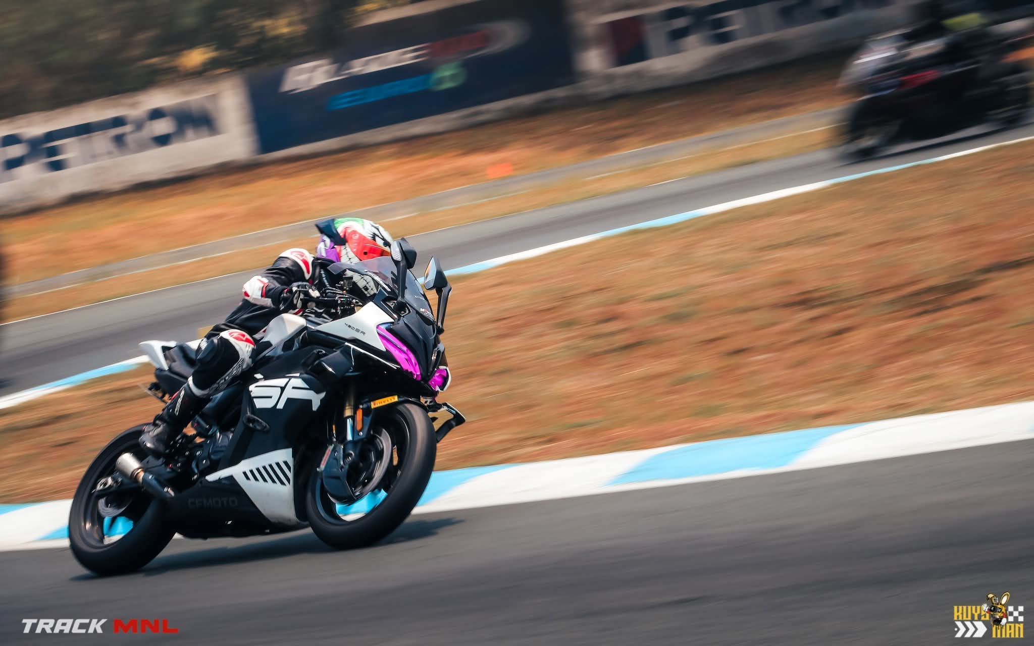 CFMOTO 450SR cornering hard on a circuit