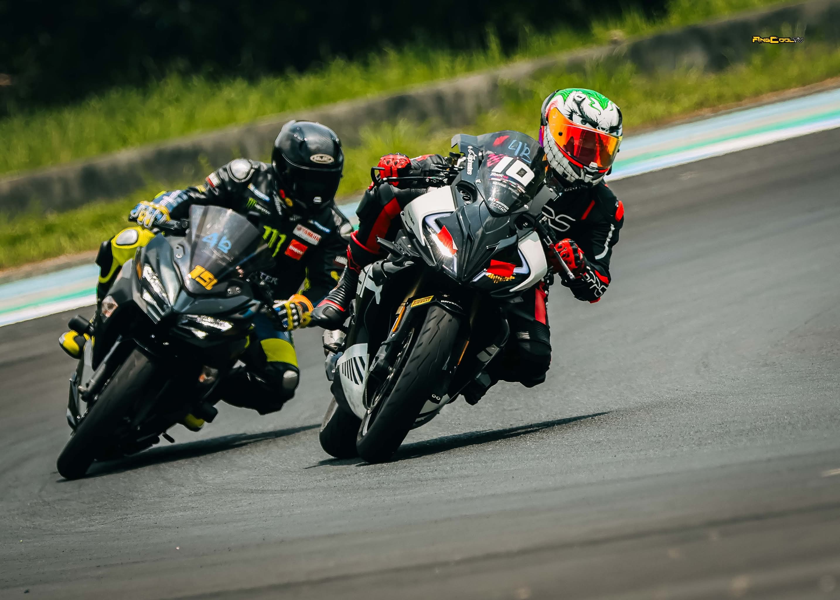 Two sport bikes cornering side by side